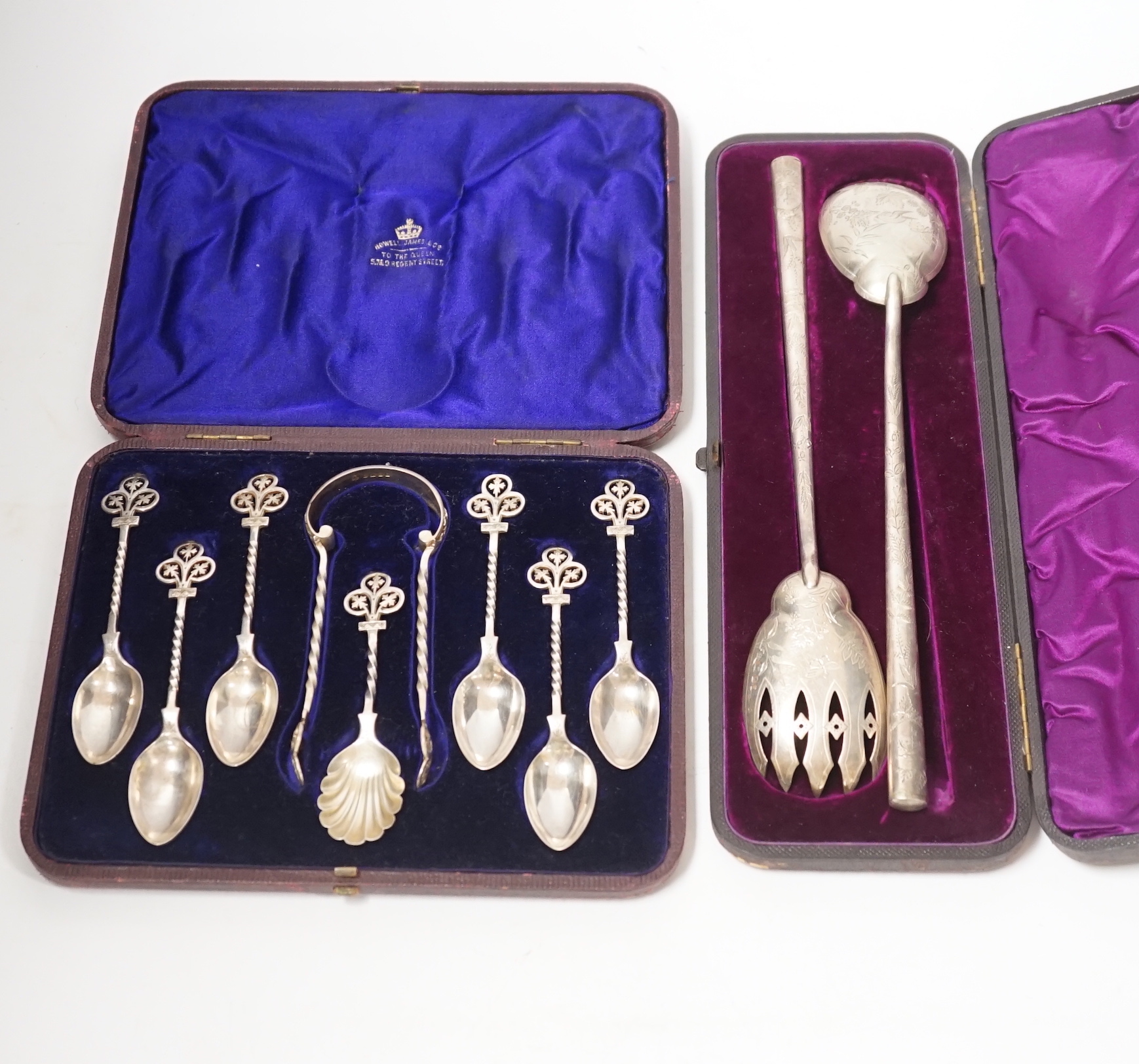 A cased pair of Victorian aesthetic period silver salad servers, Atkin Brothers, Sheffield, 1881 and a cased set of silver teaspoons, sugar spoon and tongs.